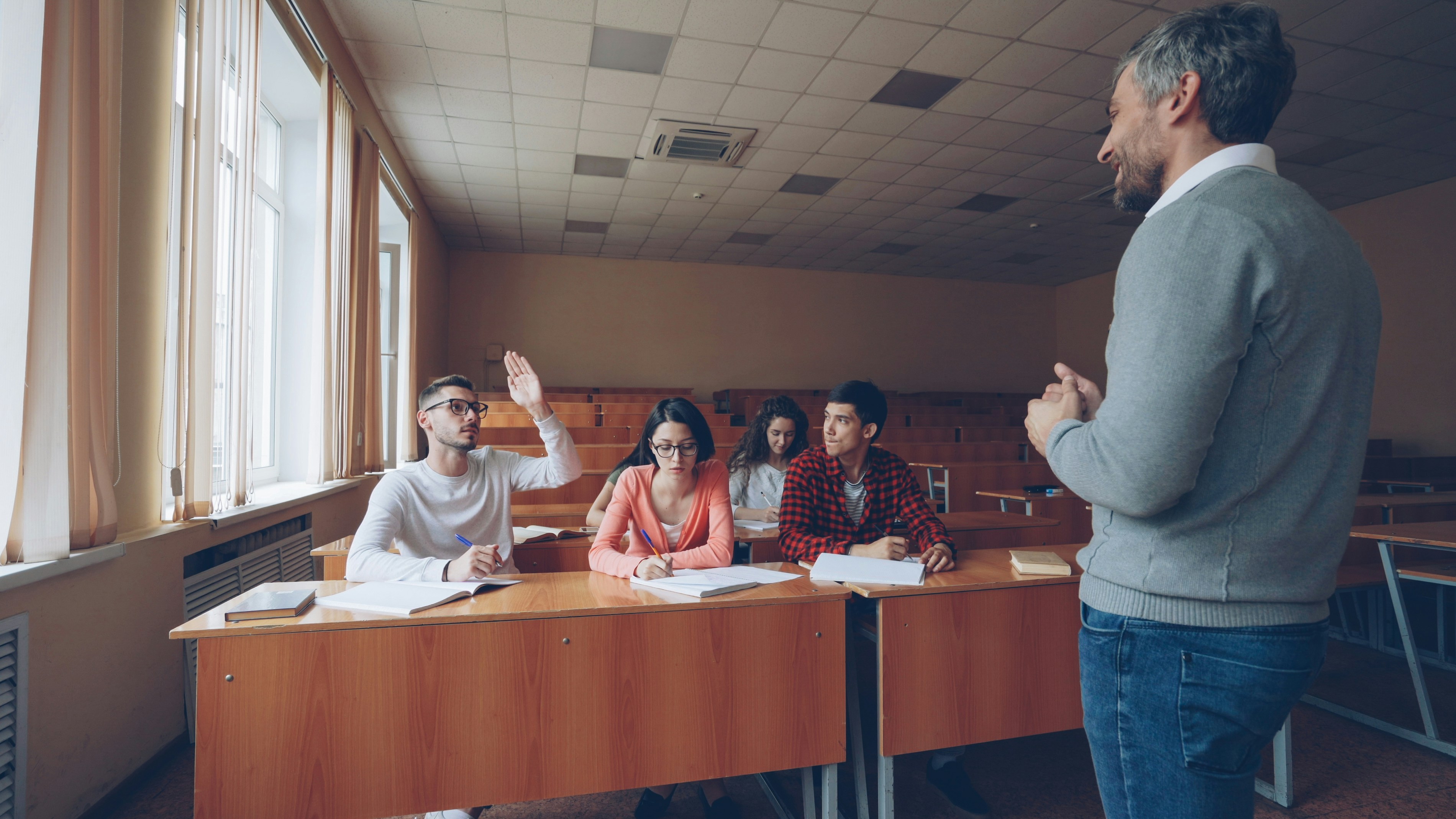 Teacher guiding students in a classroom